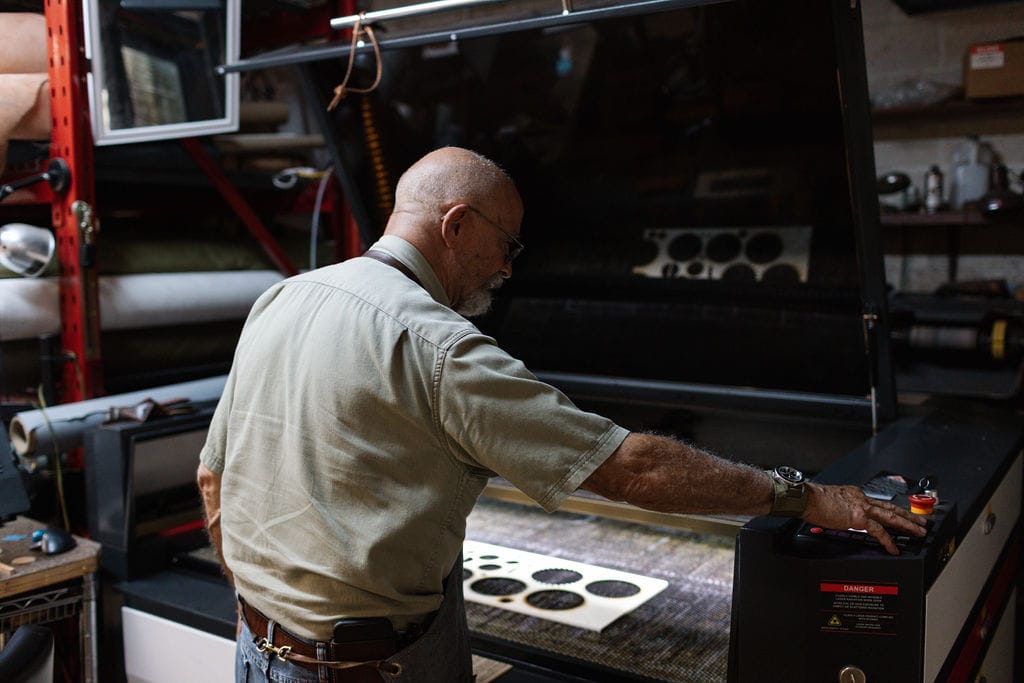 A clicker die press and racks of steel cutting dies in the Christian Workshop shop.